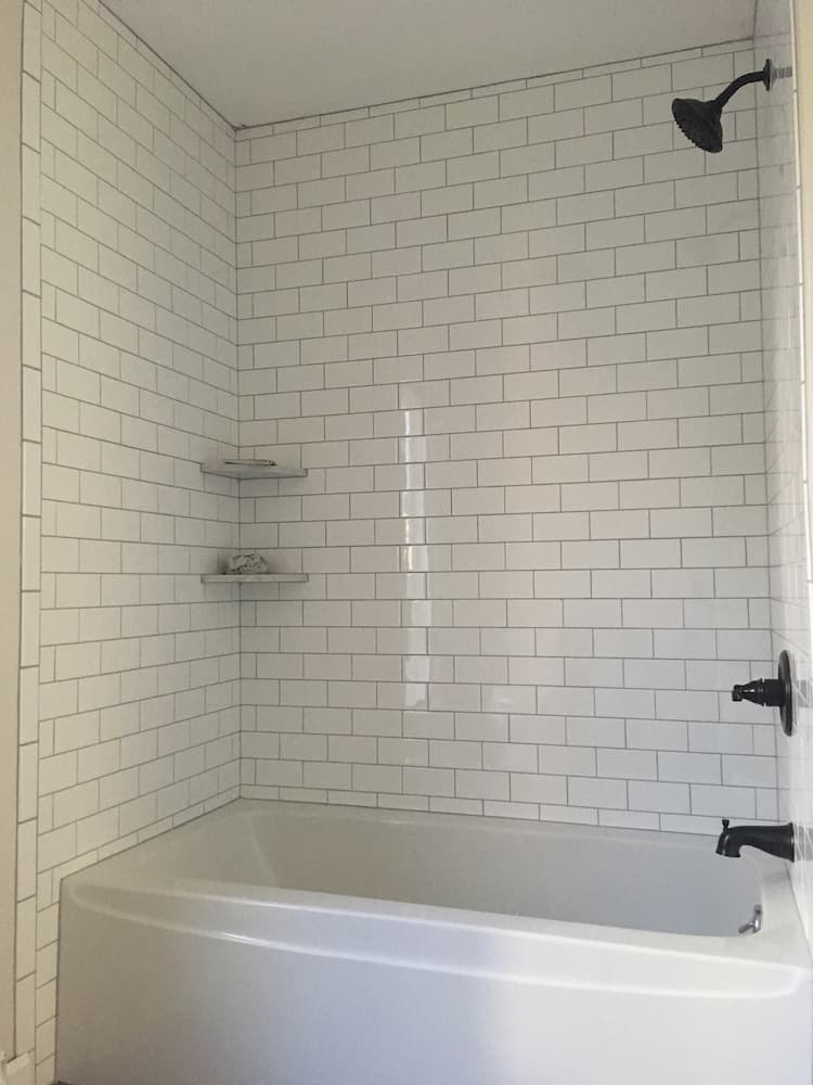 subway tile shower with black hardware