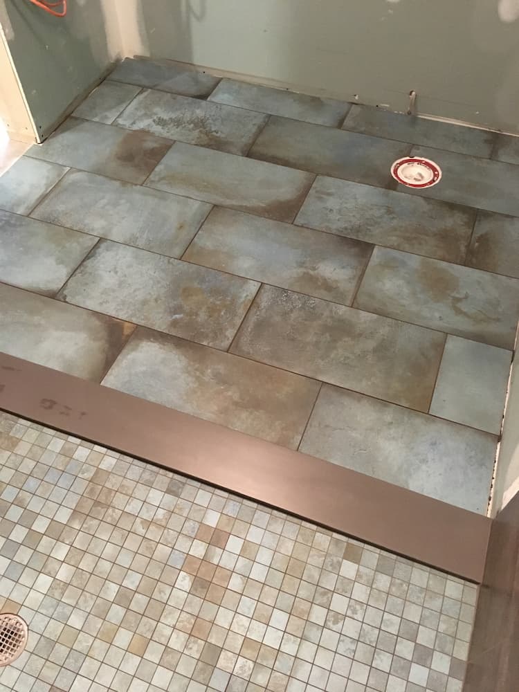 tile bathroom floor with copper details