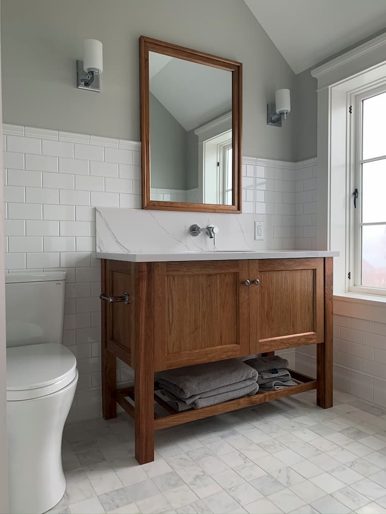 bathroom tile with brown cabinets and large mirror